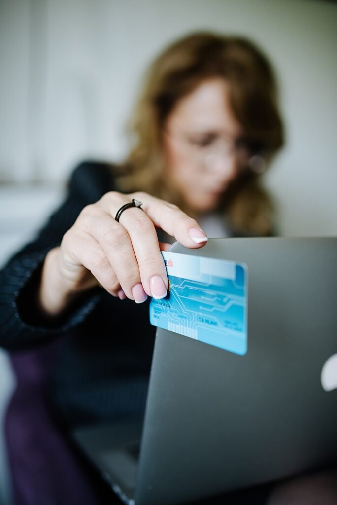 Customer shopping online with a credit card and laptop