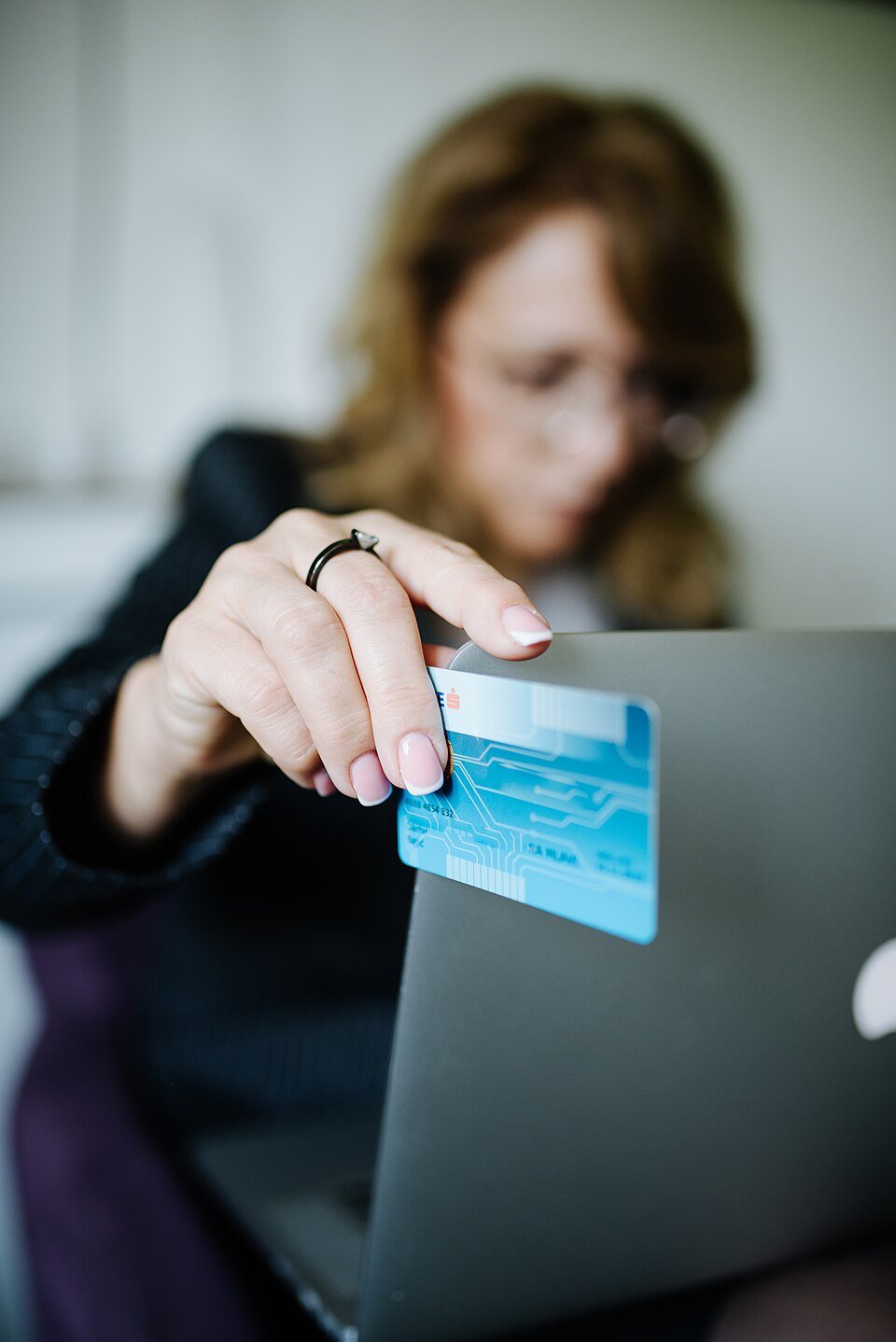 Customer shopping online with a credit card and laptop